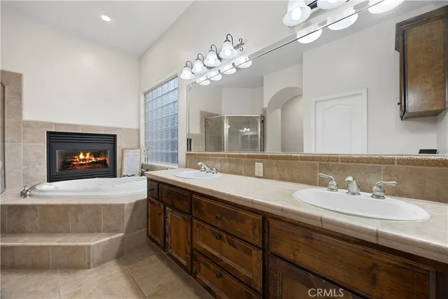 a spacious bathroom with a sink a large mirror and a bathtub
