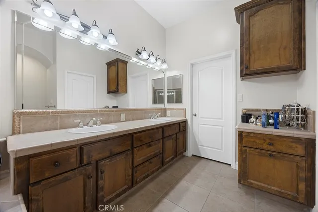 a spacious bathroom with a sink double vanity and a mirror