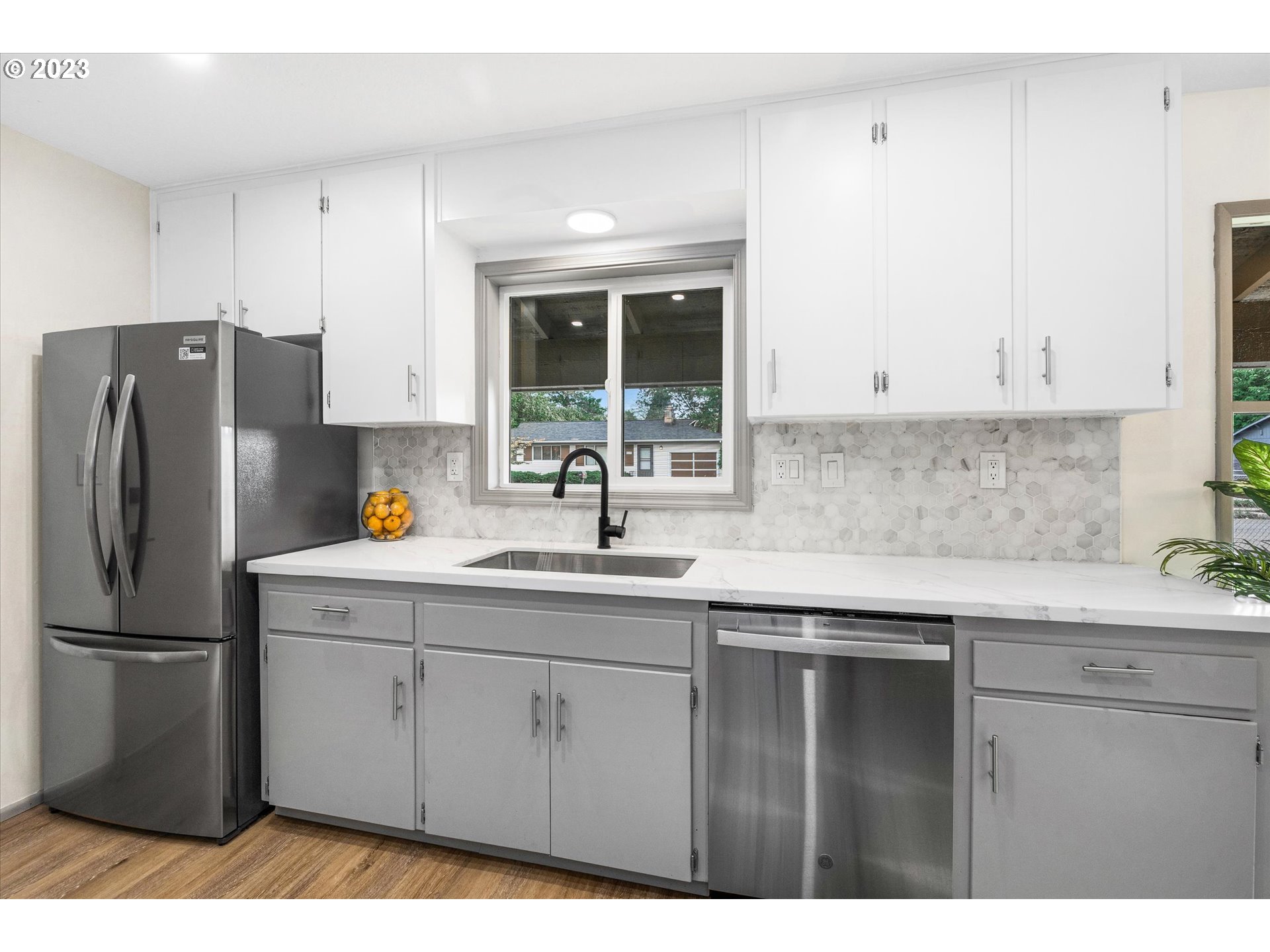 16331 Southeast Salmon Street Portland, OR 97233 - Photo 12 of 40 a kitchen with a sink a refrigerator and window