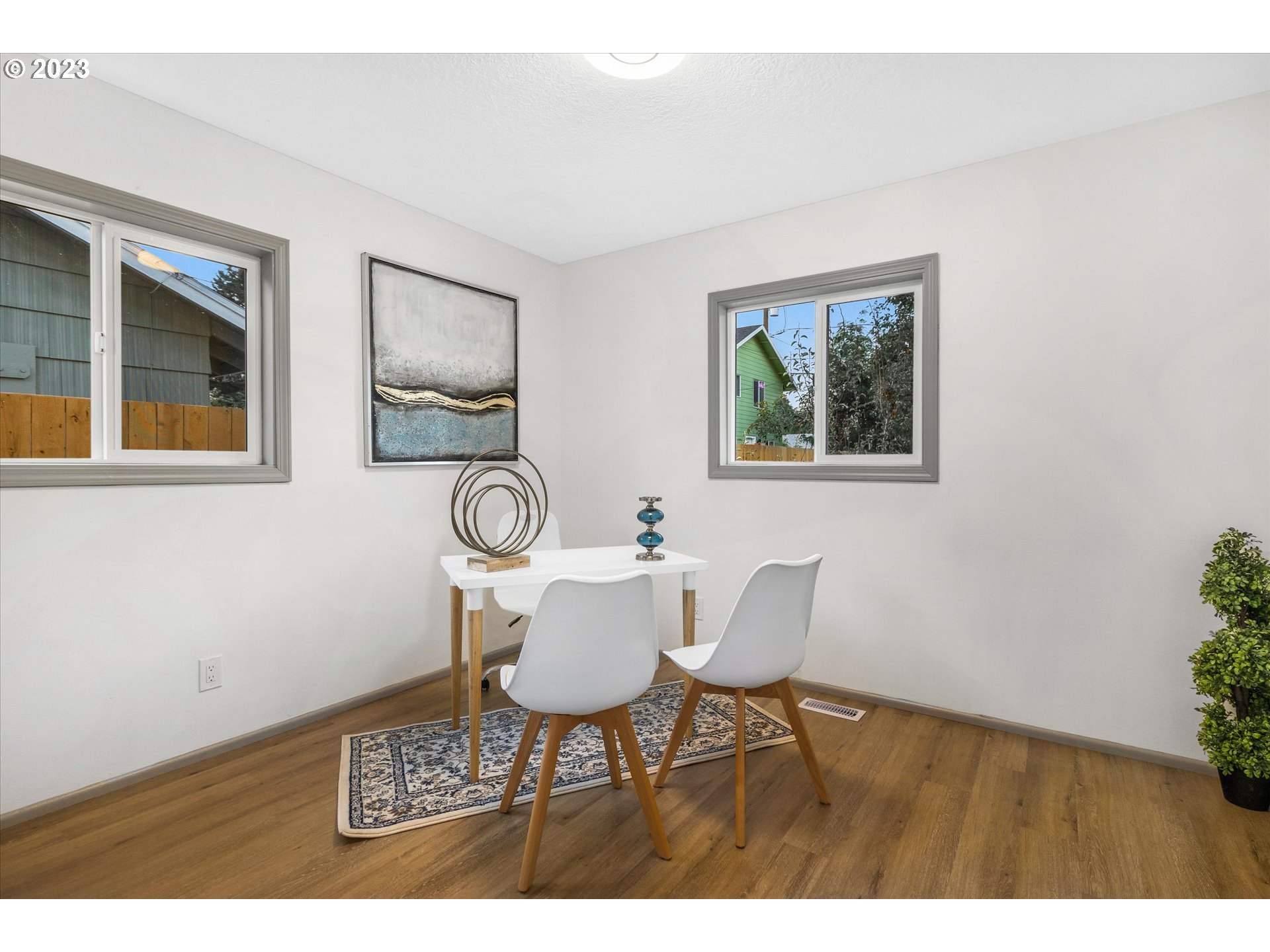 16331 Southeast Salmon Street Portland, OR 97233 - Photo 31 of 40 a view of a dining room with furniture and wooden floor