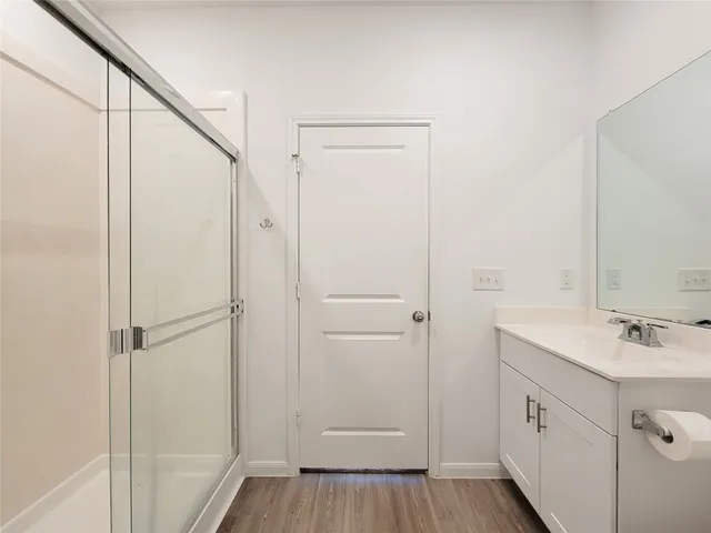 a bathroom with a shower sink and mirror