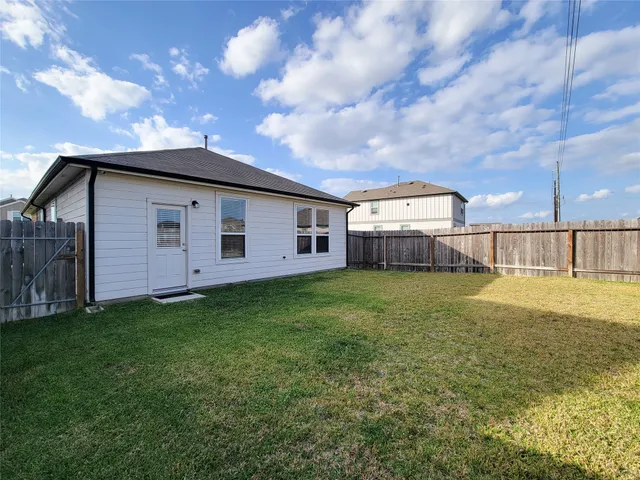a view of a house with a backyard