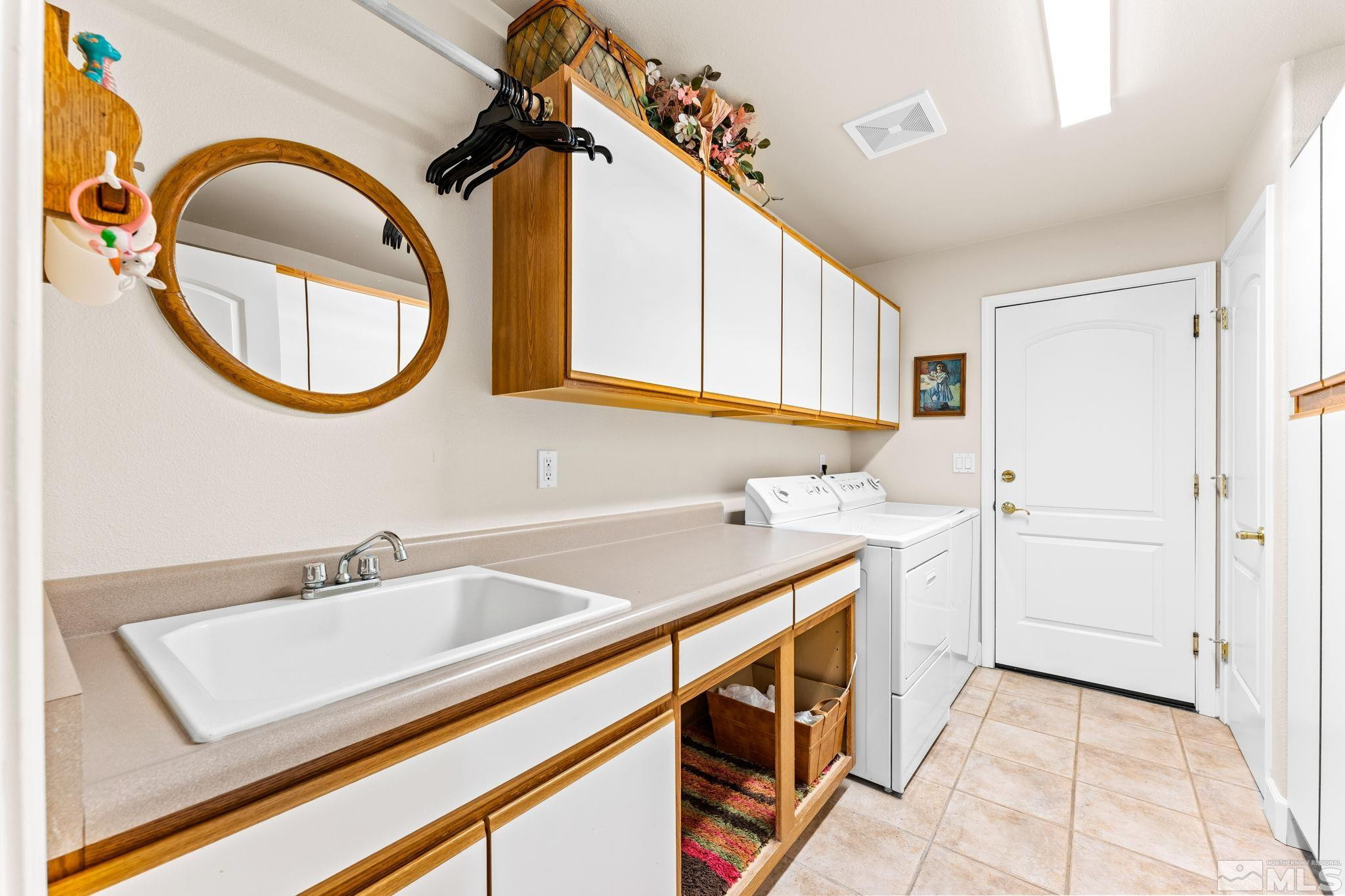 3301 Sierra Crest Way Reno, NV 89519 - Photo 29 of 37 a utility room with a sink a washer and dryer