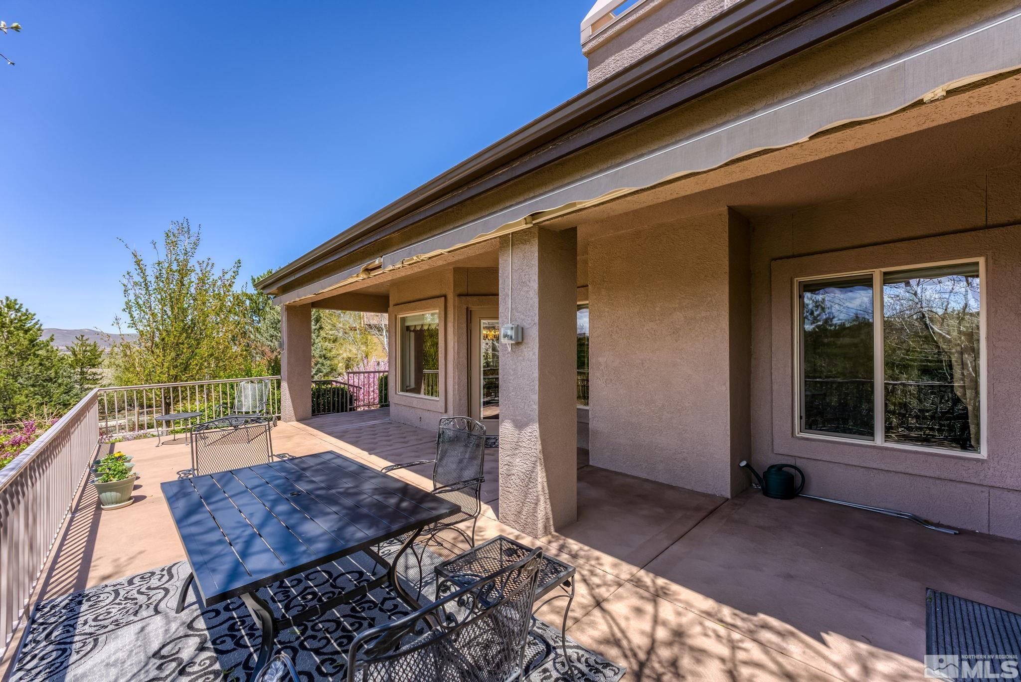 3301 Sierra Crest Way Reno, NV 89519 - Photo 35 of 37 a view of a patio with table and chairs with wooden floor and fence