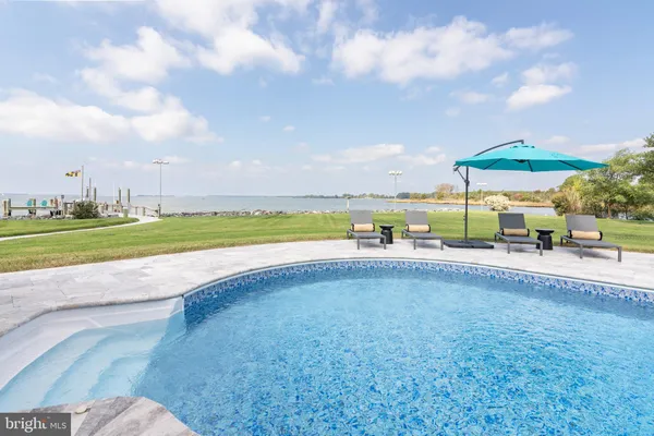 a view of a house with swimming pool and sitting area