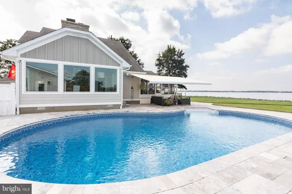 a view of a swimming pool with an ocean view