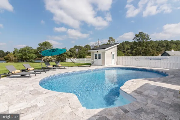 a view of a house with swimming pool and sitting area