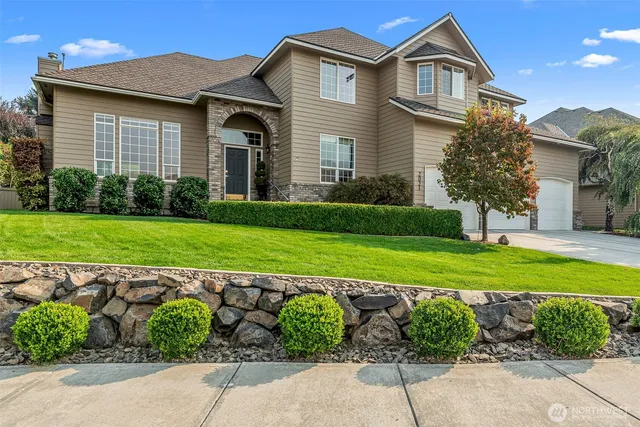 a front view of a house with a yard