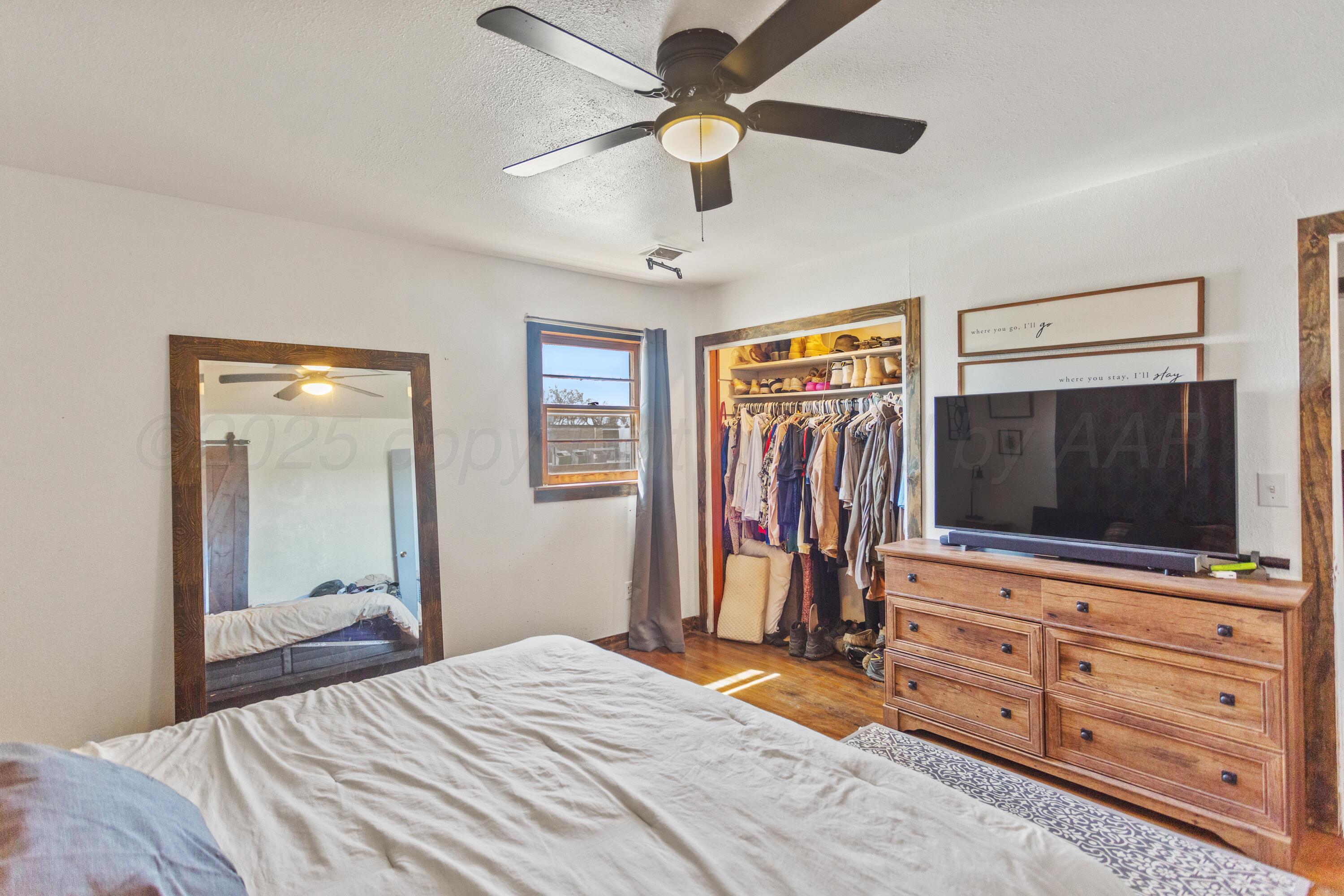 920 South Madden Street Shamrock, TX 79079 - Photo 16 of 39 a bedroom with a bed and a flat screen tv
