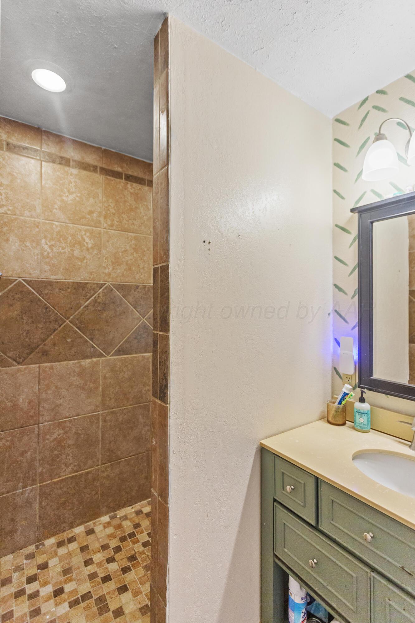 920 South Madden Street Shamrock, TX 79079 - Photo 20 of 39 a bathroom with a sink vanity granite and shower