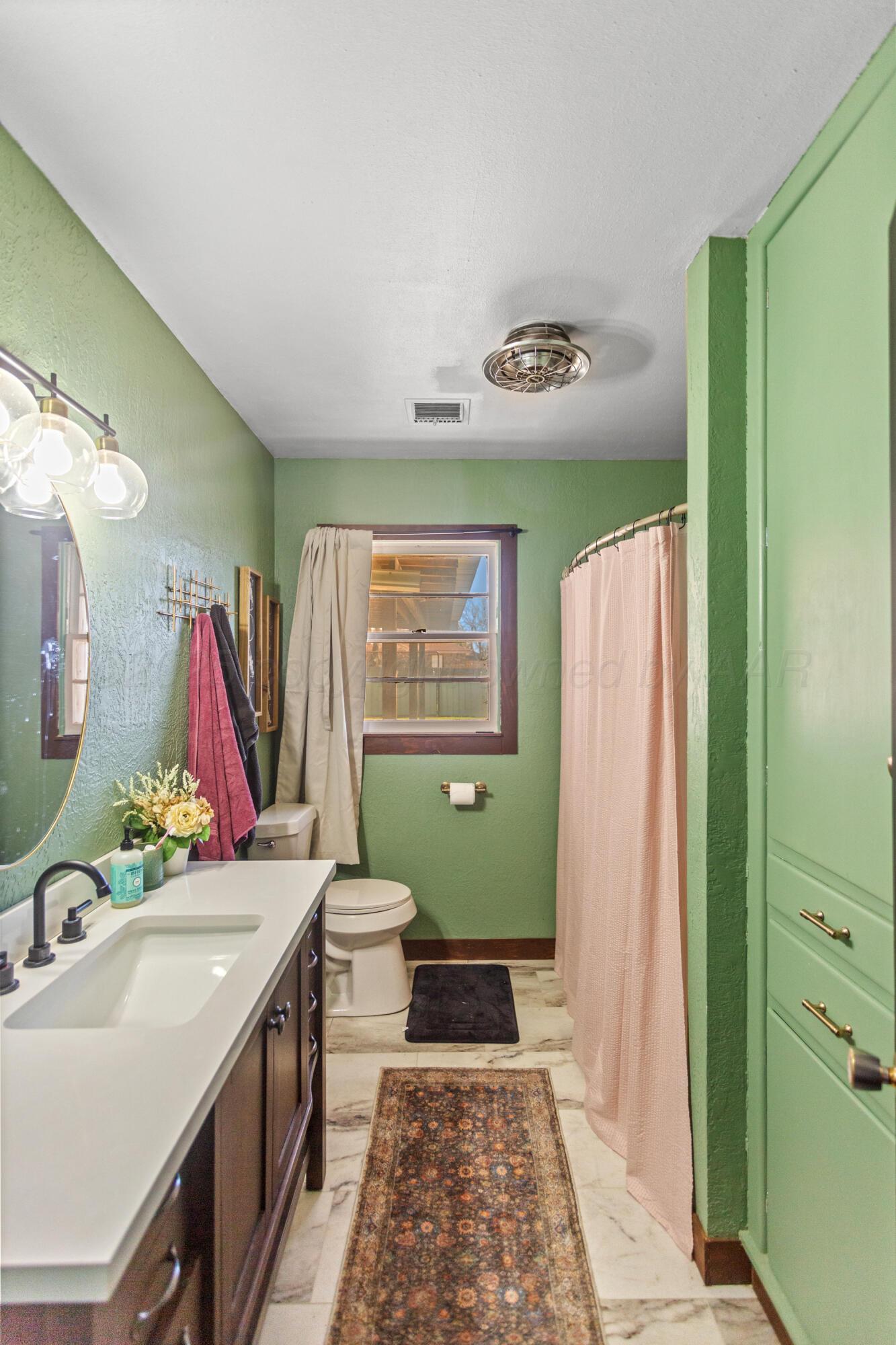 920 South Madden Street Shamrock, TX 79079 - Photo 26 of 39 a bathroom with a sink a toilet and a shower