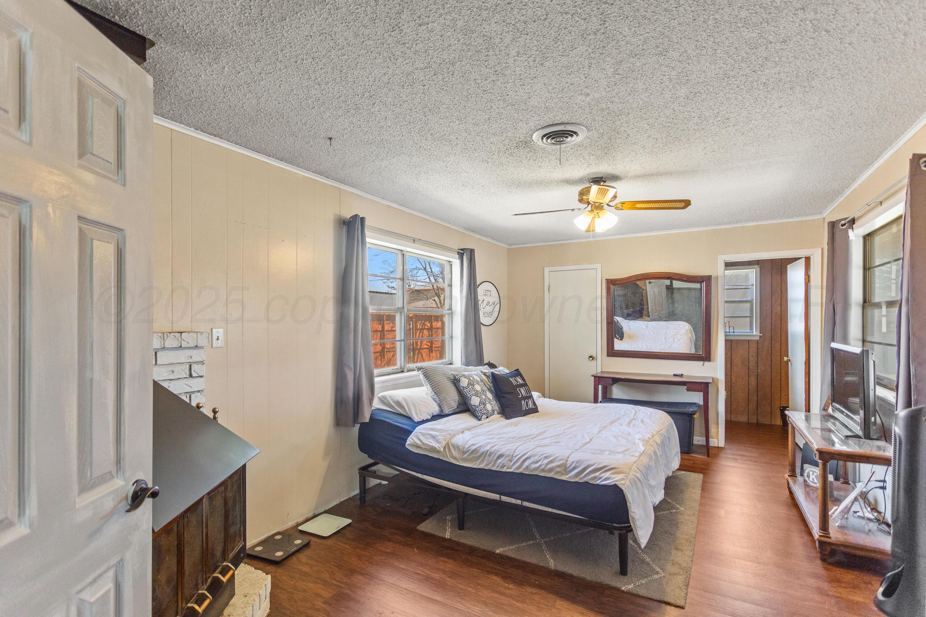 920 South Madden Street Shamrock, TX 79079 - Photo 30 of 39 a bedroom with a bed and wooden floor