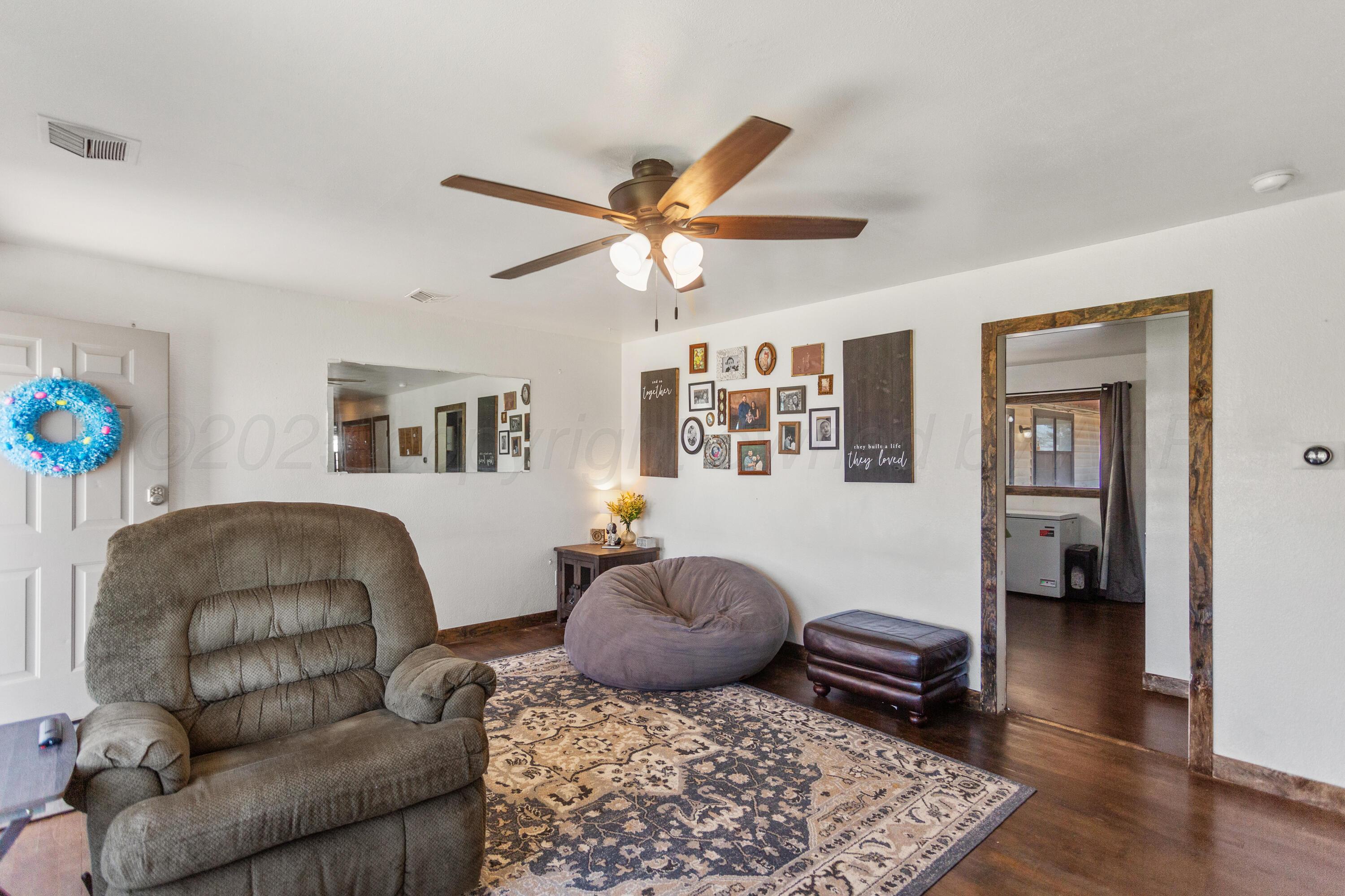 920 South Madden Street Shamrock, TX 79079 - Photo 6 of 39 a living room with furniture and wooden floor