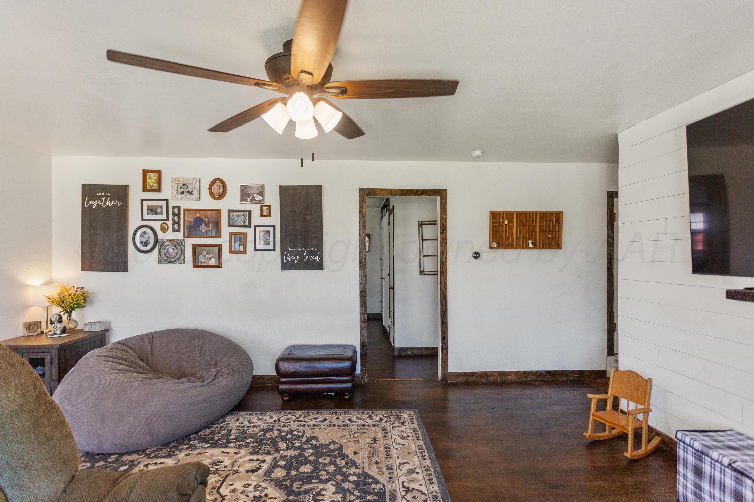 920 South Madden Street Shamrock, TX 79079 - Photo 7 of 39 a bedroom with furniture and wooden floor