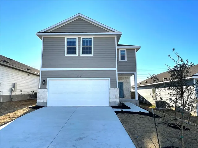 a front view of a house with a yard
