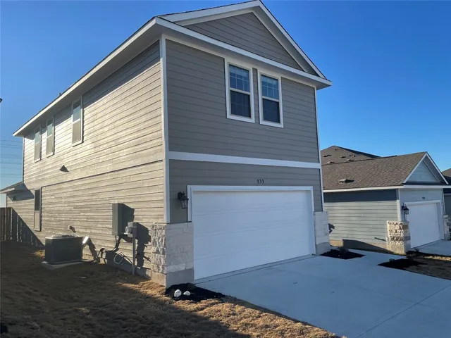 a front view of a house with a garage