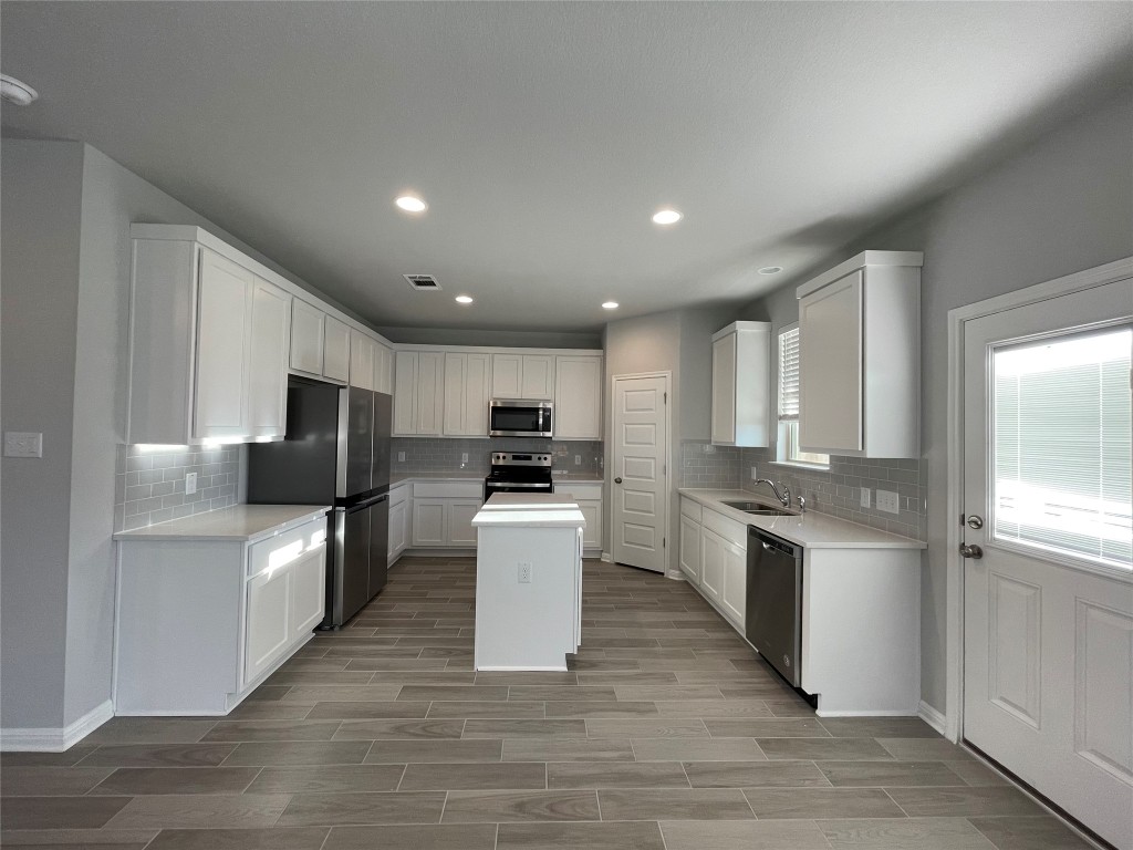 133 Old Stagecoach Road Jarrell, TX 76537 - Photo 6 of 23 a kitchen with stainless steel appliances granite countertop a refrigerator stove microwave and sink