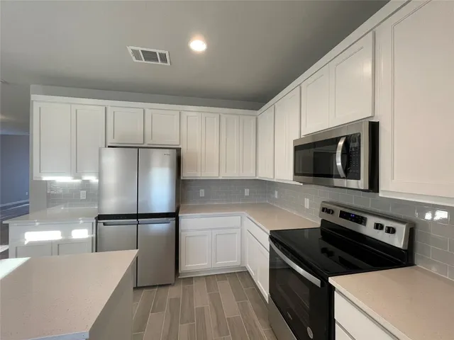 a kitchen with a sink a stove and refrigerator