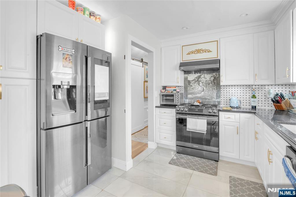 170 Tenafly Road Englewood, NJ 07631 - Photo 11 of 40 a kitchen with stainless steel appliances granite countertop a refrigerator and a stove