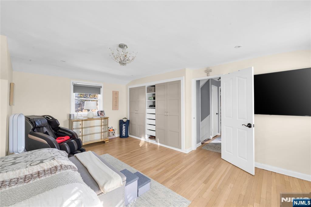 170 Tenafly Road Englewood, NJ 07631 - Photo 19 of 40 a bedroom with a bed and a flat screen tv