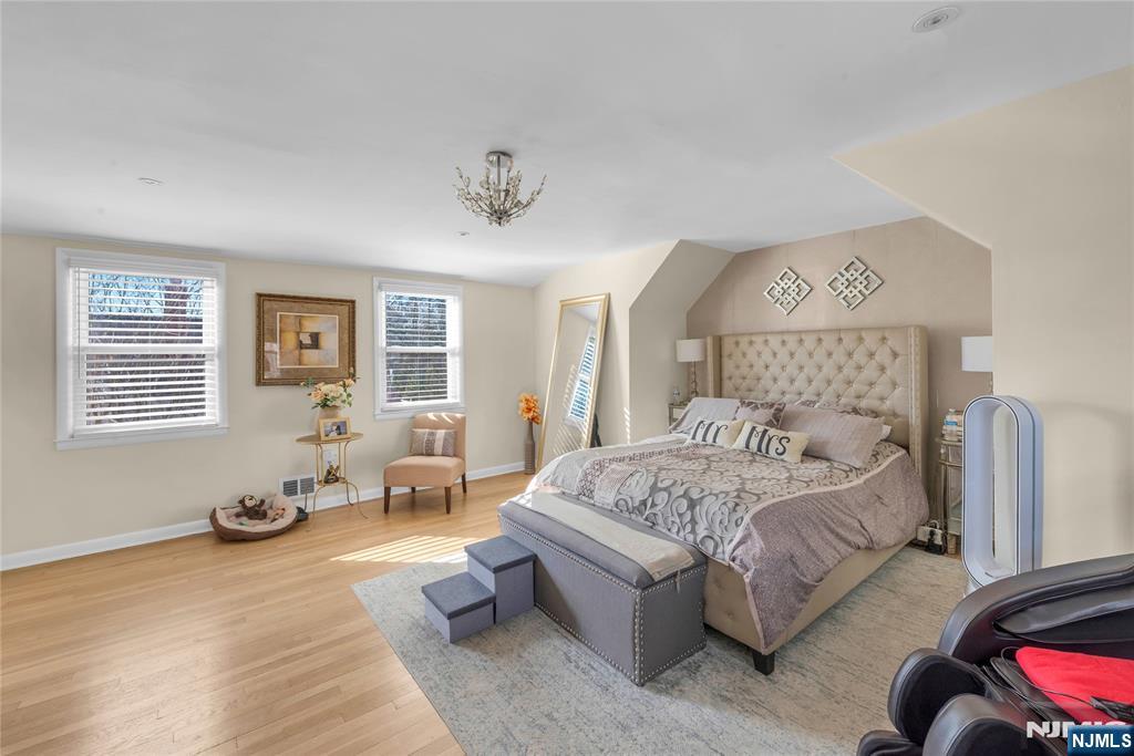 170 Tenafly Road Englewood, NJ 07631 - Photo 21 of 40 a bedroom with a bed and wooden floor