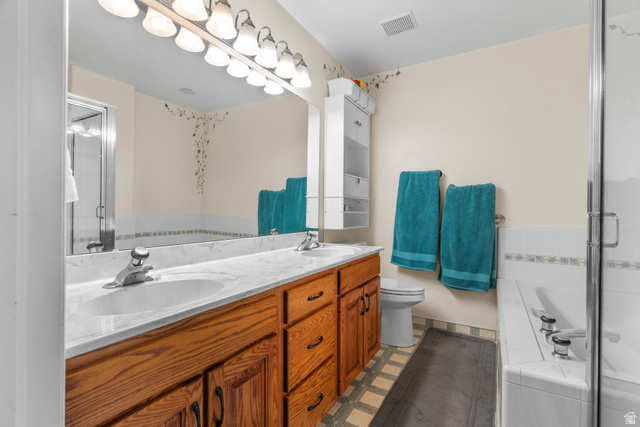 5727 South 3550th Street West Roy, UT 84067 - Photo 10 of 49 Master ensuite bathroom featuring a double vanity with wood cabinetry and a light-toned countertop, dual sinks, bath and shower