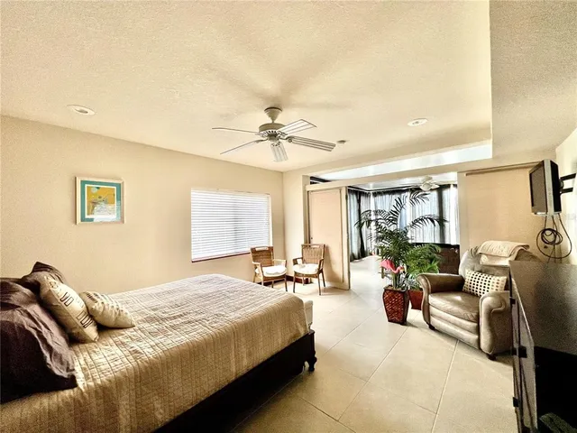 a bedroom with furniture and a large window