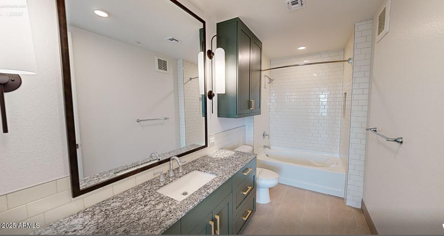 98 South River Drive, Unit C1 Tempe, AZ 85288 - Photo 11 of 20 a bathroom with a granite countertop sink a mirror and a bathtub