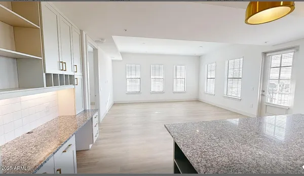 a view of an empty room with a fireplace and a window