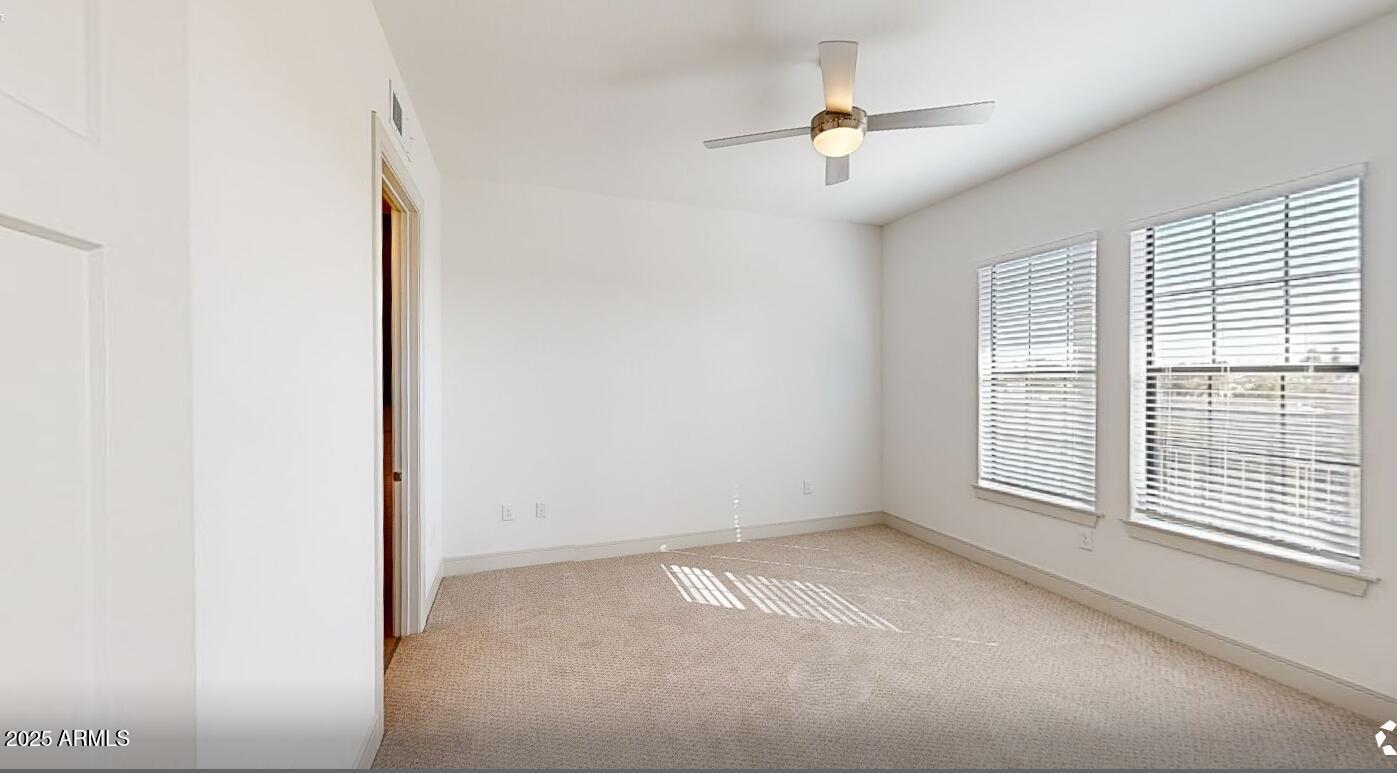 98 South River Drive, Unit C1 Tempe, AZ 85288 - Photo 5 of 20 a view of an empty room with a window
