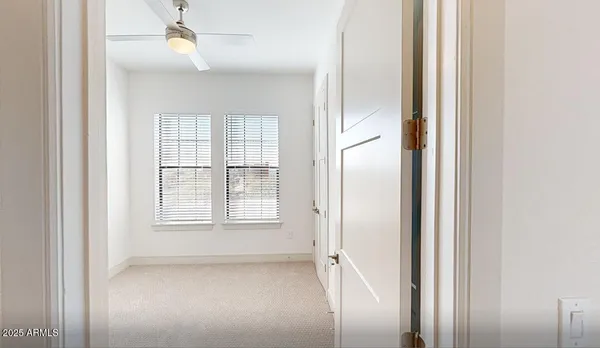 an empty room with windows and closet