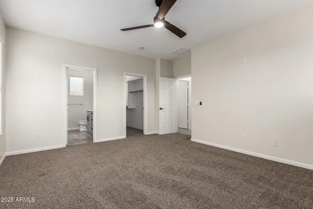 a view of empty room with ceiling fan