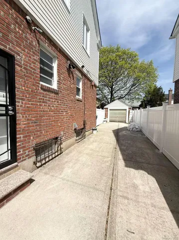 a view of a backyard with snow on the road