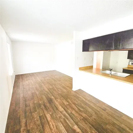 a view of kitchen and empty room