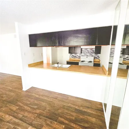 a kitchen with a sink appliances and cabinets