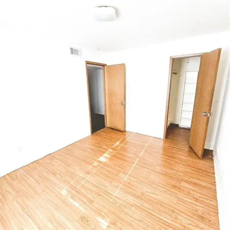 a view of a room with wooden floor and chair
