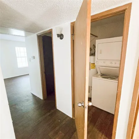 an entryway with wooden floor and a cabinet