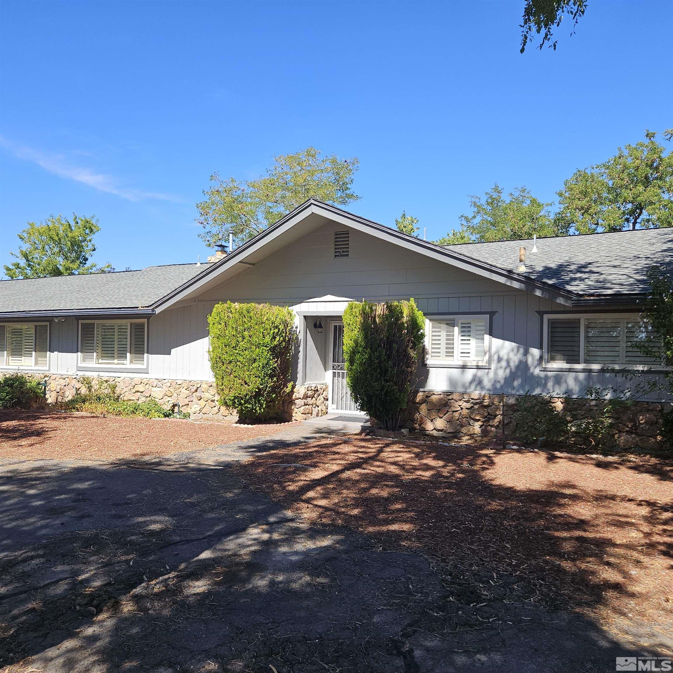 14430 Rancheros Drive Reno, NV 89521 - Photo 1 of 39 a front view of a house with a yard and a garage