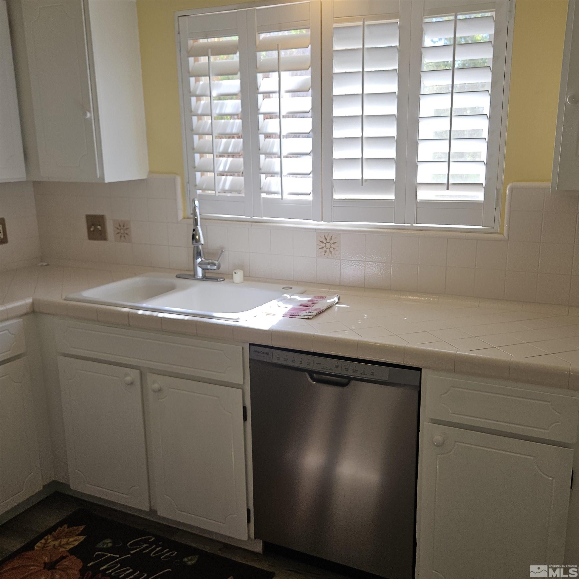 14430 Rancheros Drive Reno, NV 89521 - Photo 6 of 39 a utility room with a sink and a window