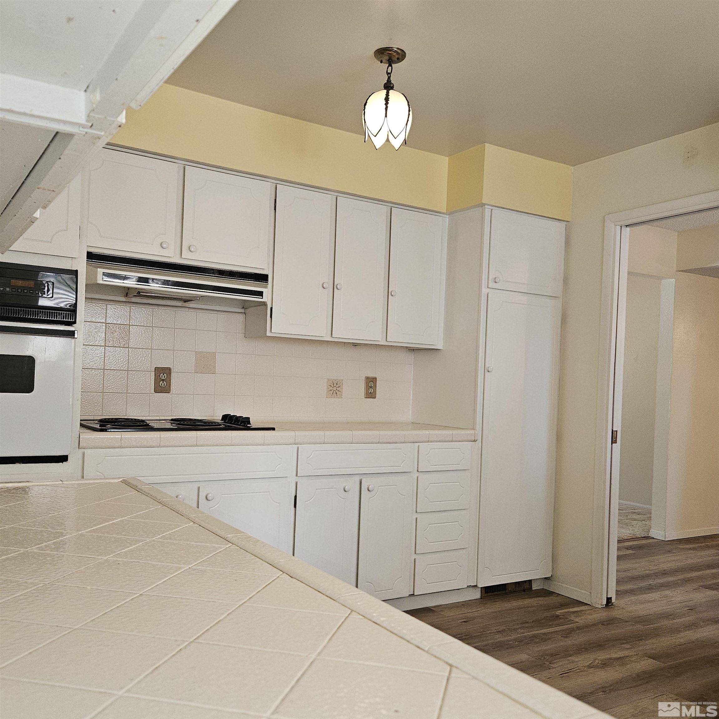 14430 Rancheros Drive Reno, NV 89521 - Photo 9 of 39 a kitchen with cabinets and appliances