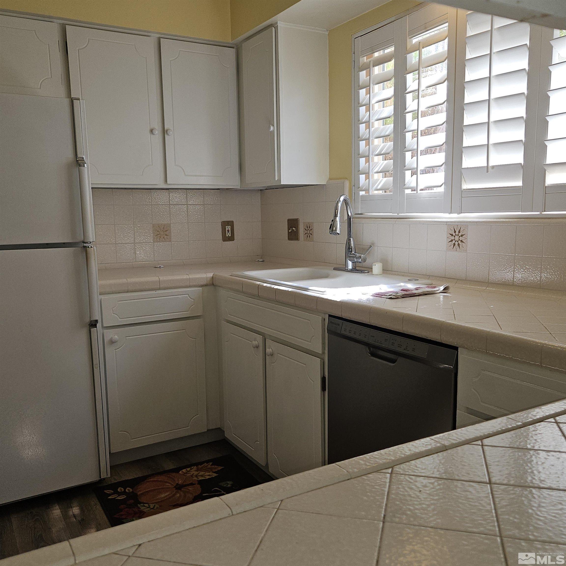 14430 Rancheros Drive Reno, NV 89521 - Photo 10 of 39 a kitchen with a sink cabinets and window
