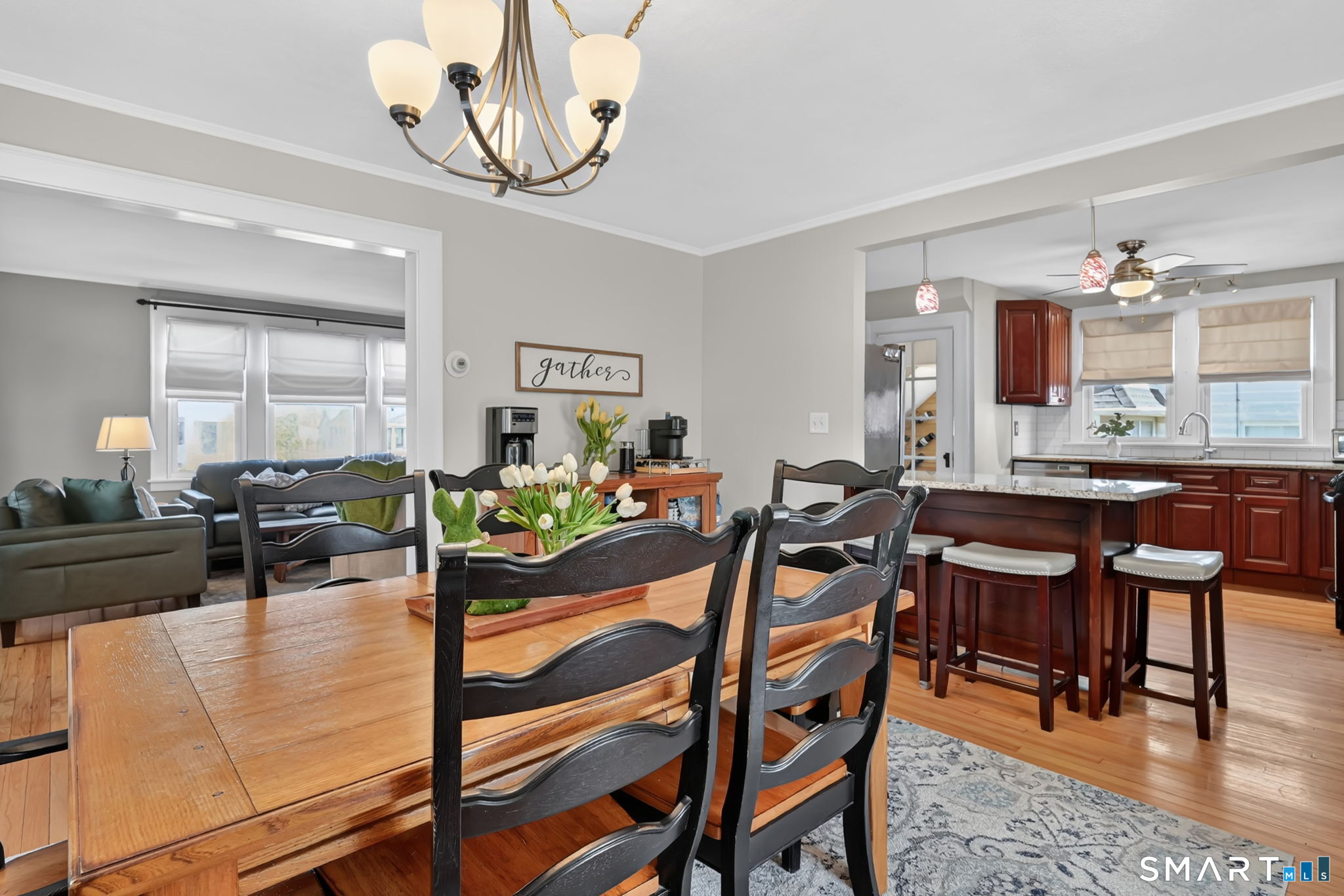 31 Somerset Street Wethersfield, CT 06109 - Photo 4 of 18 a view of a dining room and livingroom with furniture wooden floor a rug a painting and a chandelier