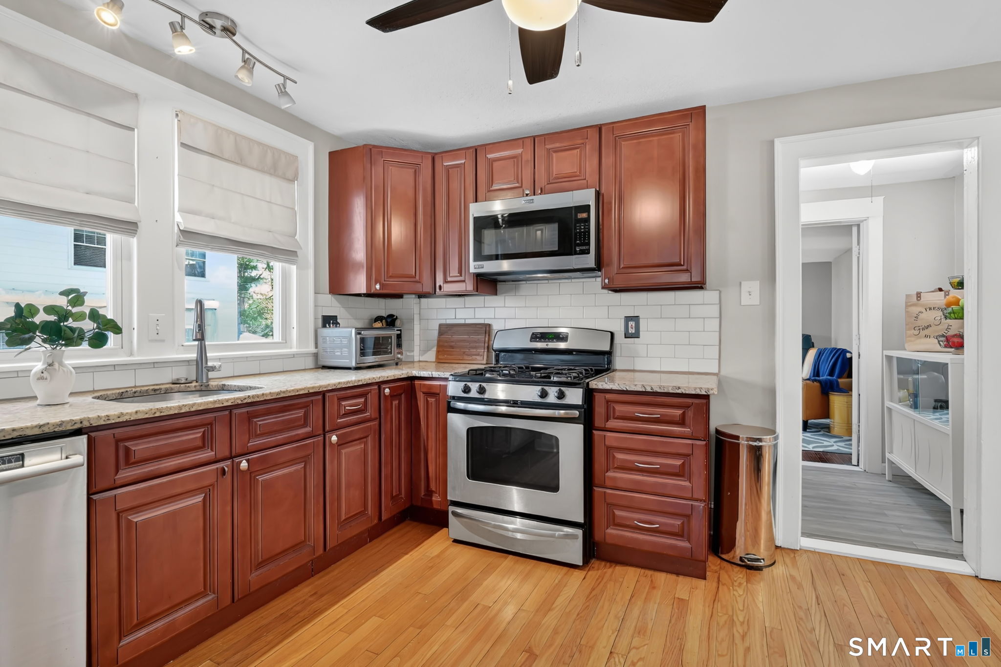 31 Somerset Street Wethersfield, CT 06109 - Photo 5 of 18 a kitchen with stainless steel appliances granite countertop wooden floors and granite counter tops