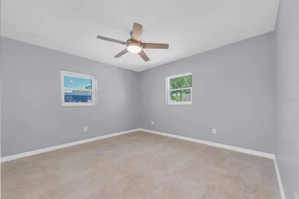 a white toilet sitting next to a bathroom sink and a window