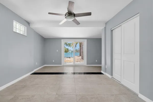 a row of palm trees and swimming pool in the backyard of a house