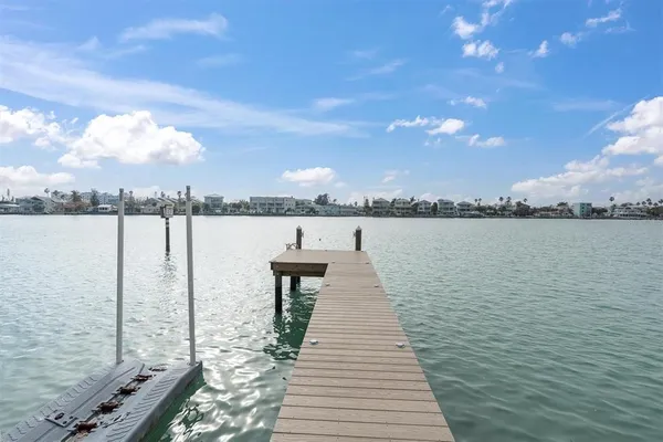 an aerial view of residential houses with outdoor space and river