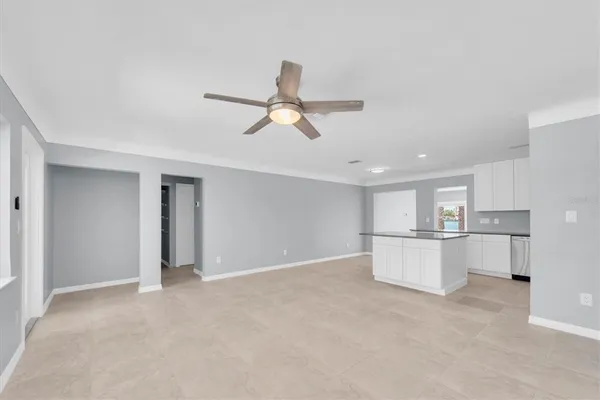 a kitchen with stainless steel appliances white cabinets and a refrigerator