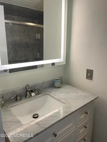 a bathroom with a sink and mirror