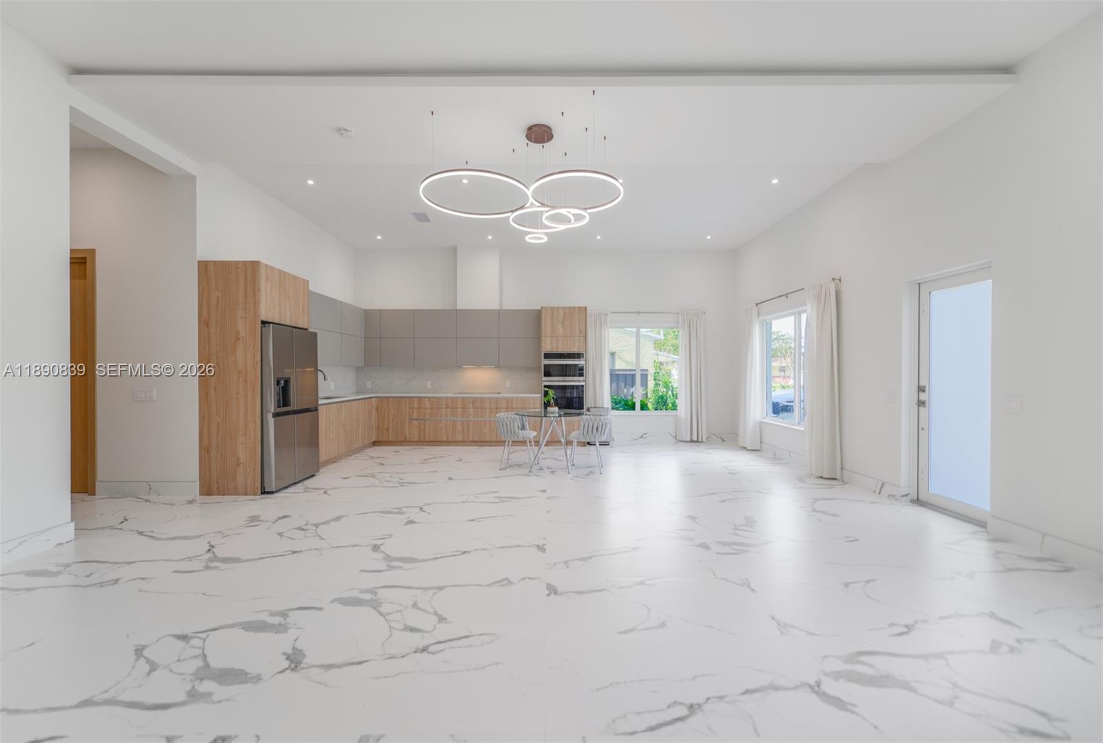 635 Southwest 9th Street Hallandale Beach, FL 33009 - Photo 3 of 38 a view of a kitchen with a sink and a refrigerator