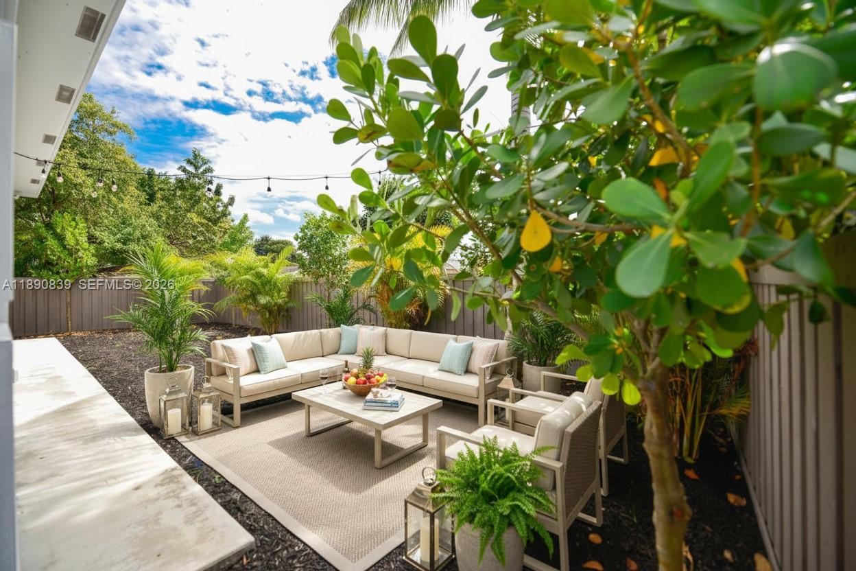 635 Southwest 9th Street Hallandale Beach, FL 33009 - Photo 37 of 38 a view of a patio with table and chairs and potted plants